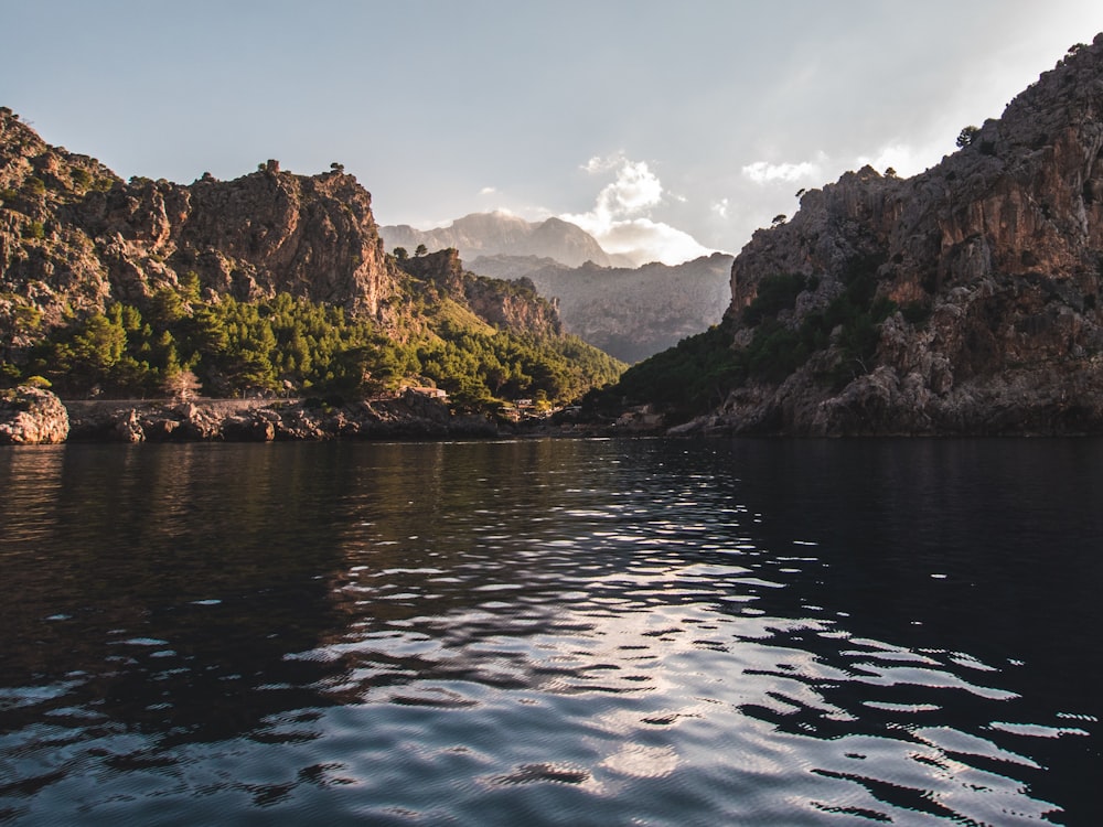 landscape photography of body of water surrounded by hills