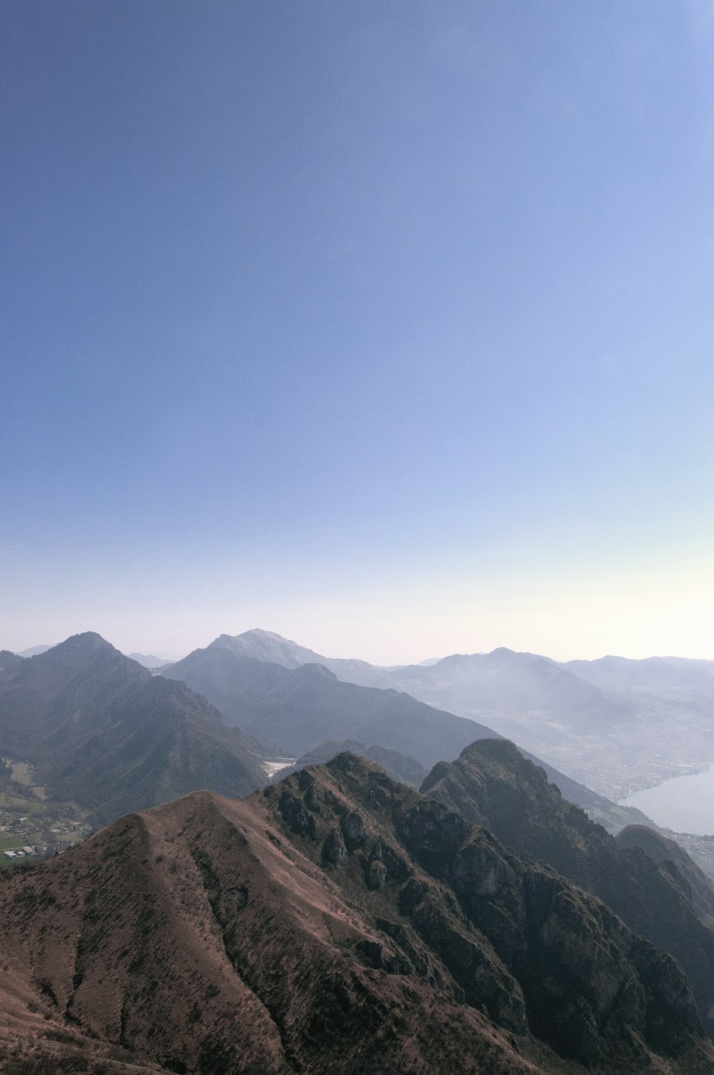 brown and green mountain peaks in foggy day