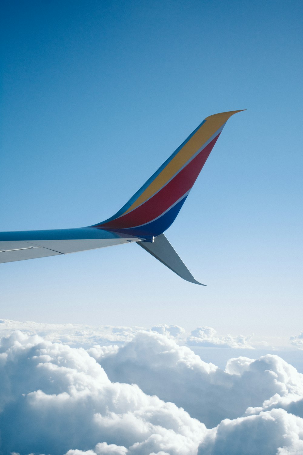 passenger plane flying over white clouds