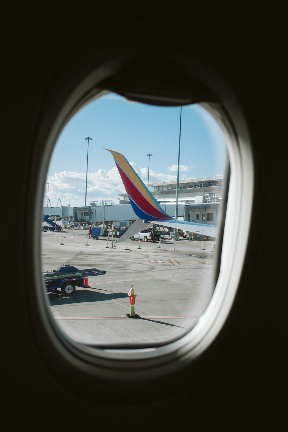 airliner window showing airport during daytime