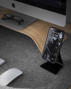 black smartphone near white iMac