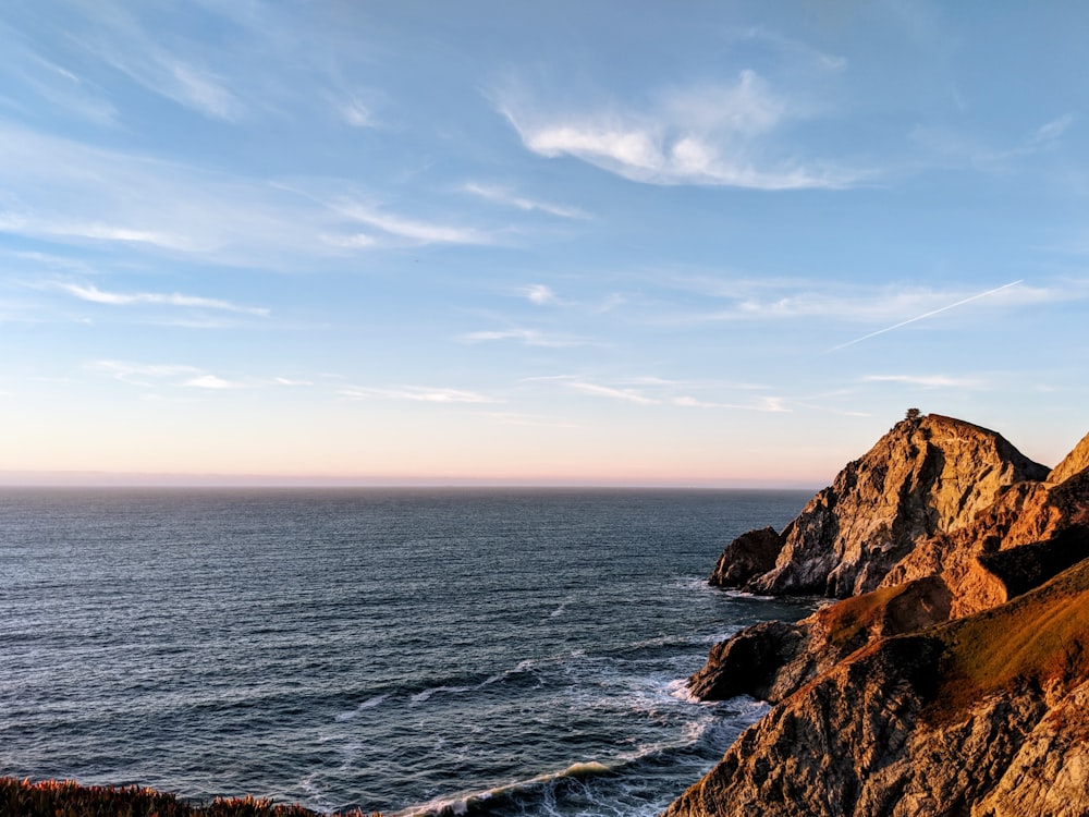 rock formation near the sea during daytime