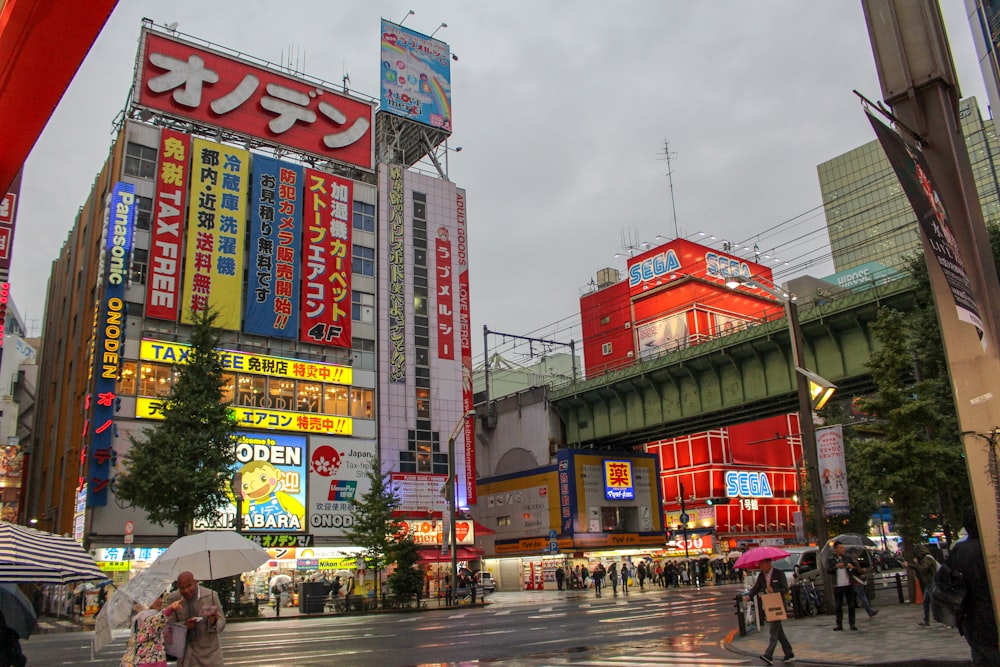 people on sidewalks in rainy city street