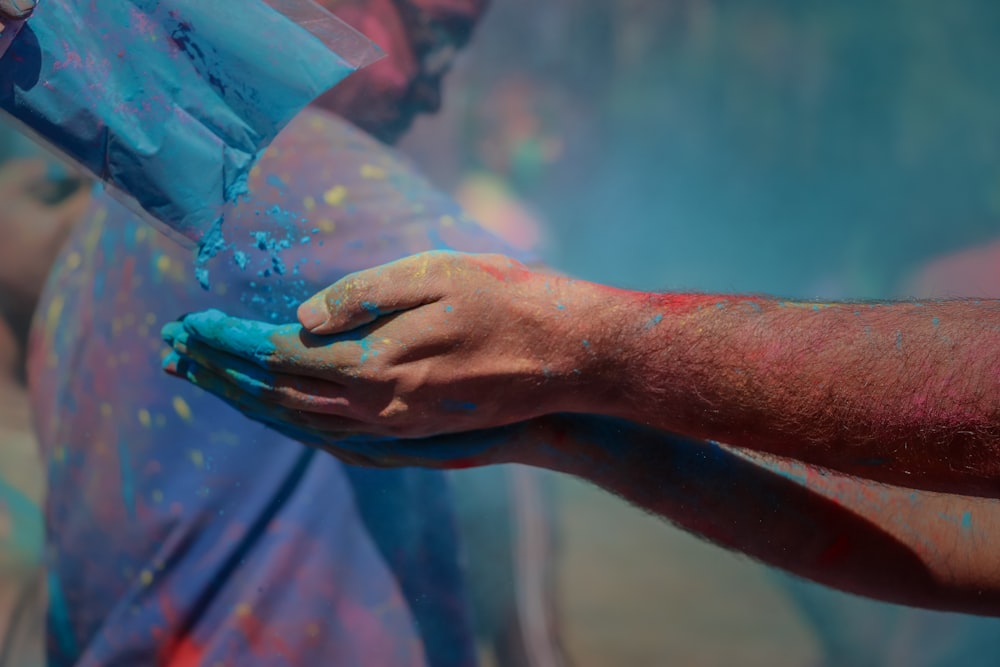 person catching blue powder