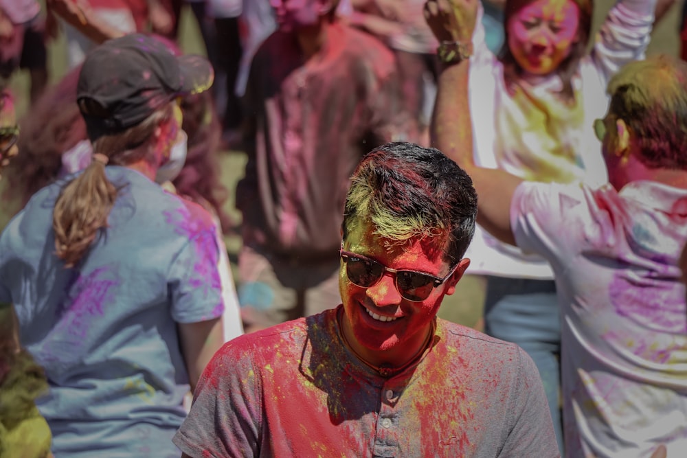 people gathering outdoor with paints during daytime