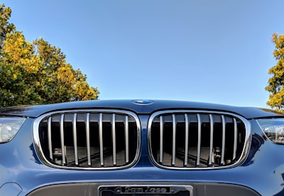 Close-up of a freshly replaced windshield on a white pickup truck with a clear blue sky background.