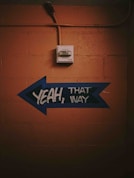 blue and black arrow signage