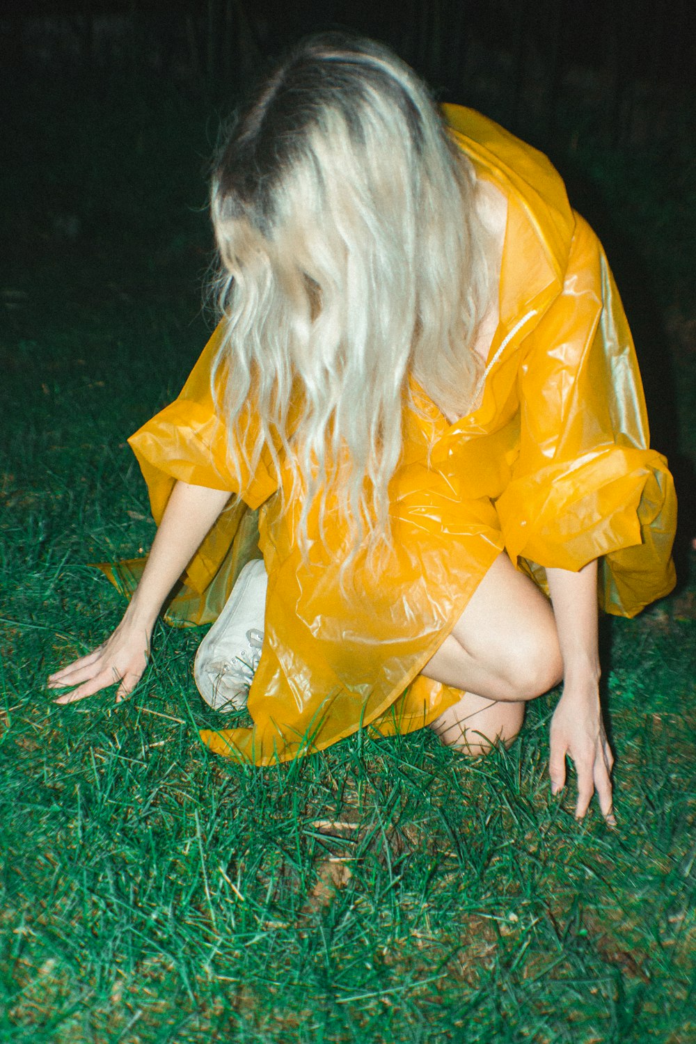 woman kneeling on green grass