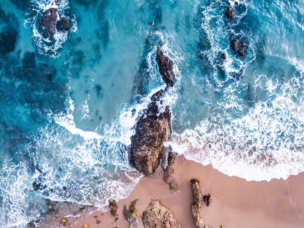 aerial photography of seashore with rock formations during daytime