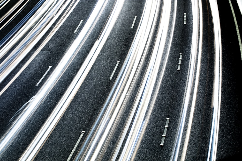 a long exposure photo of a highway at night