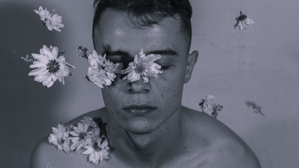 grayscale photo of portrait man floating flowers