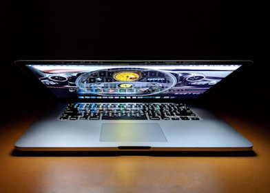 A professional desk showing a laptop screen with vehicle licensing forms filled out.