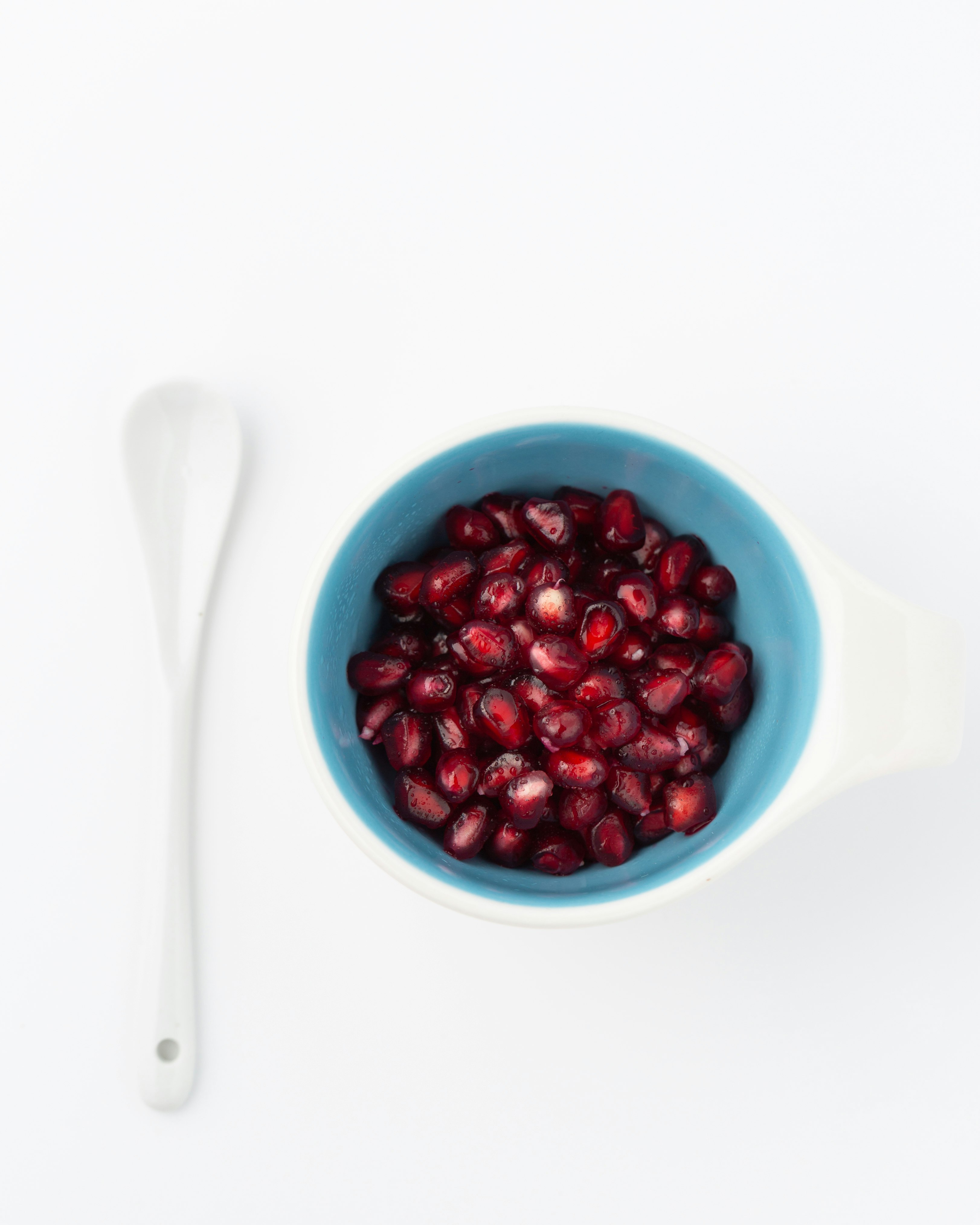red pomegranate seed on blue cup