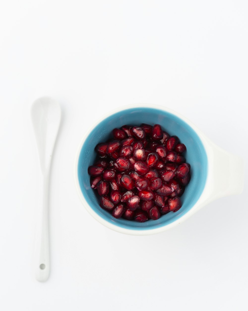red pomegranate seed on blue cup