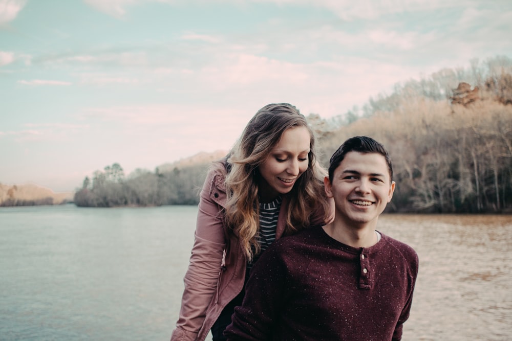 woman wearing pink cardigan and man wearing brown long-sleeved shirt