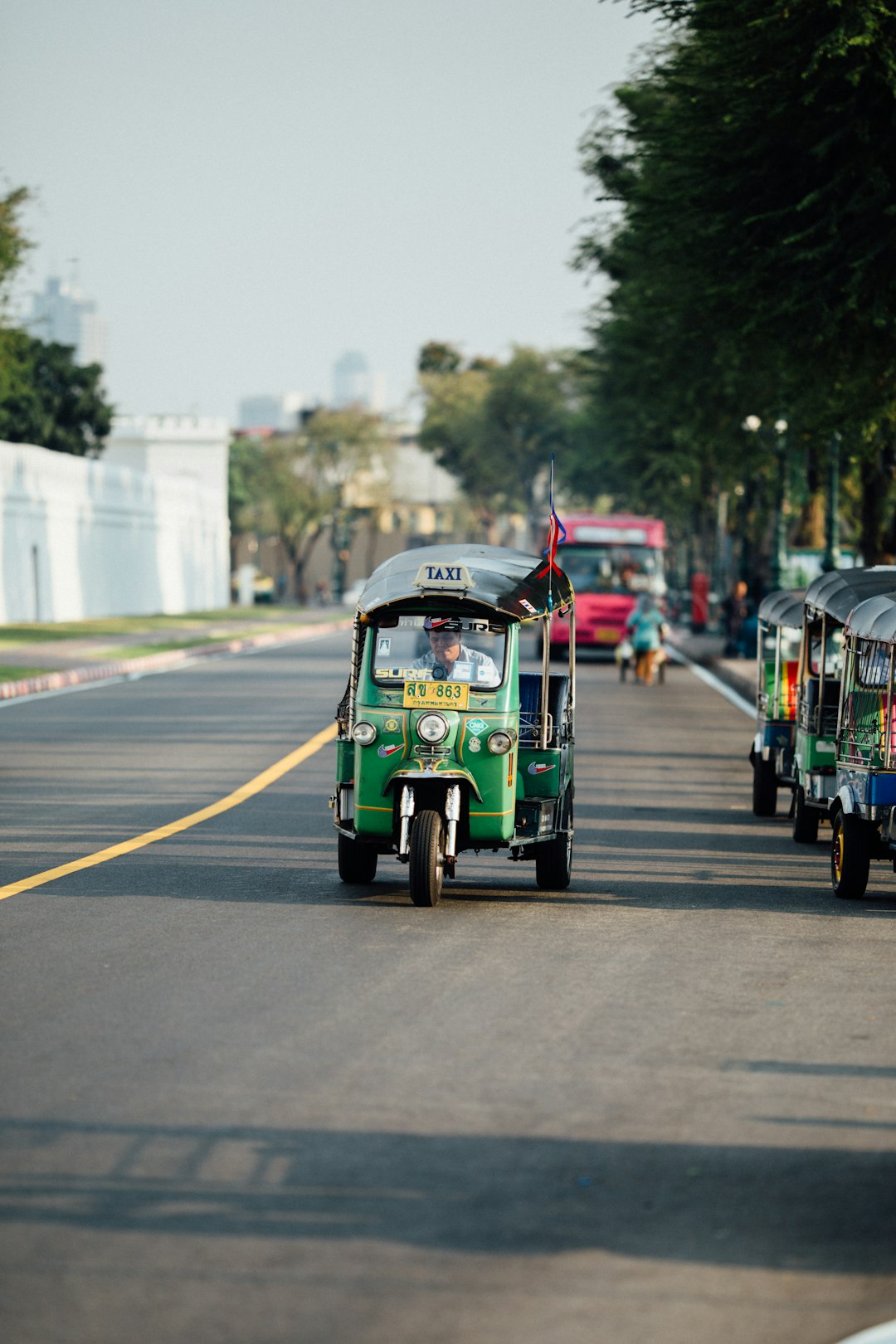 man riding auto rickshaw during daytime