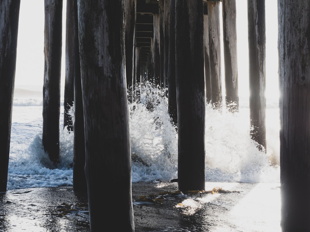 water waves crashing on the docking board base