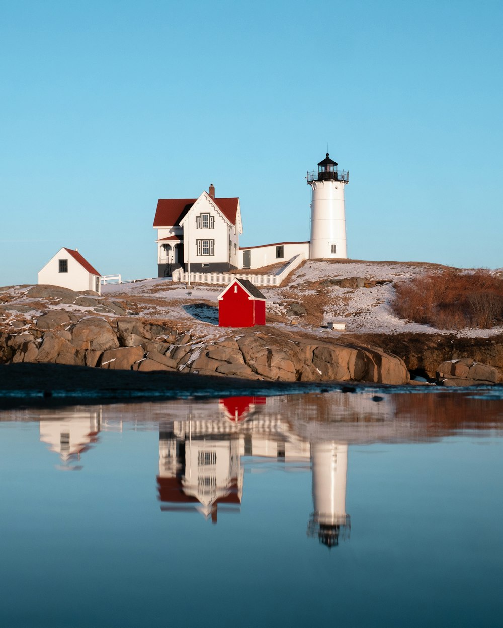 white lighthouse on moutnain