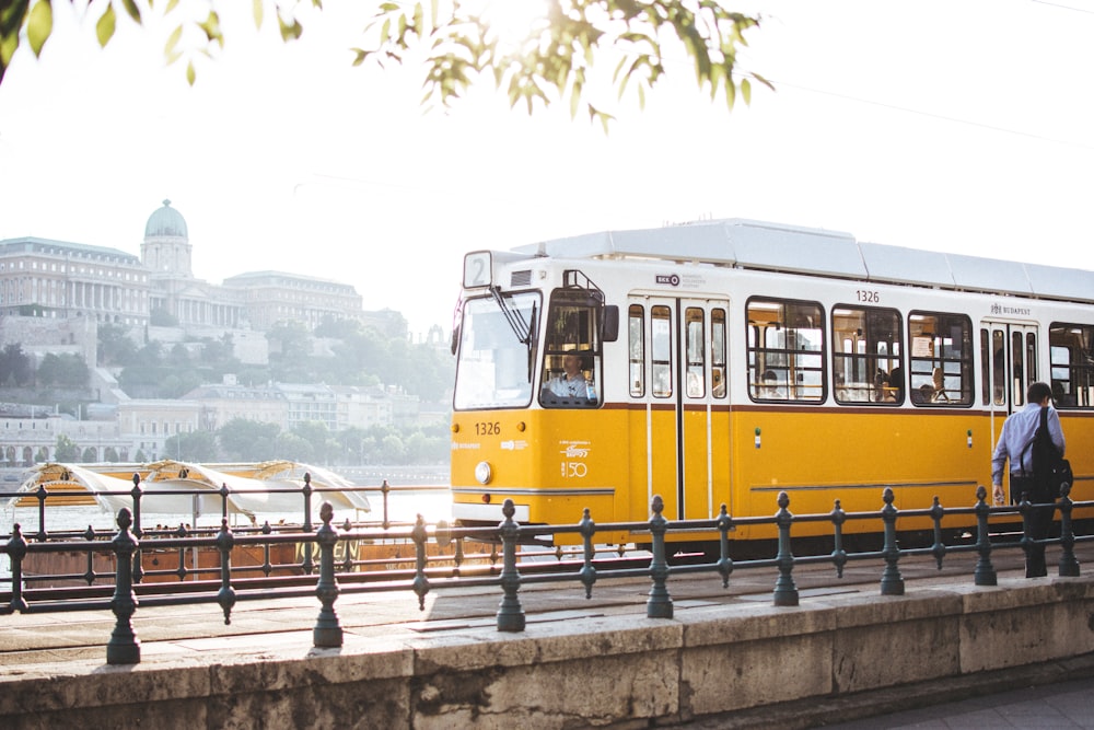 man standing in front of yellow train