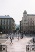 A bustling European city square alive with street performers and cafes.
