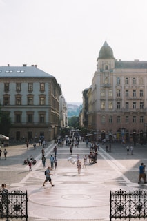 A bustling European city square alive with street performers and cafes.