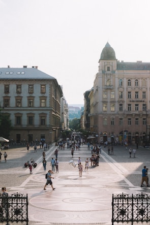 A lively European city square bustling with travelers and street cafes