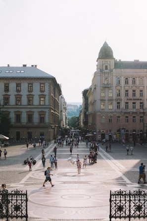 A bustling European city square filled with diverse people engaging in lively conversation under historic architecture.
