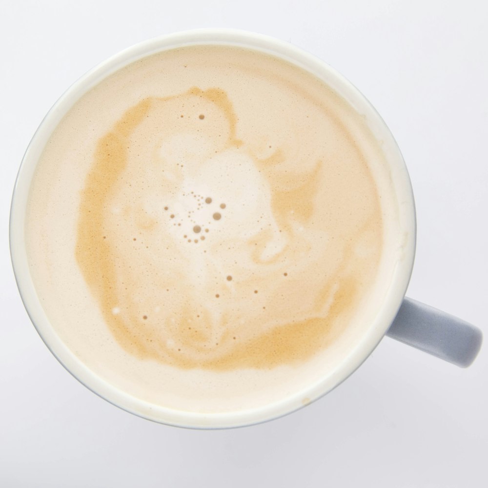 white ceramic coffee cup with coffee