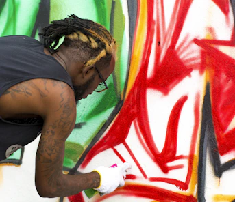 man painting on wall