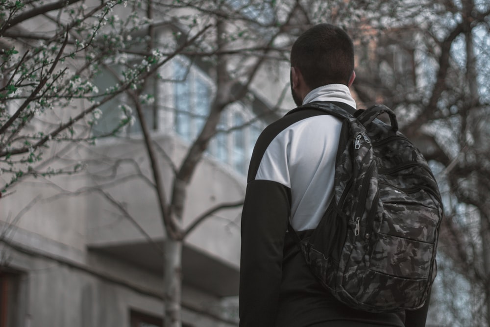 man standing under tree during daytime