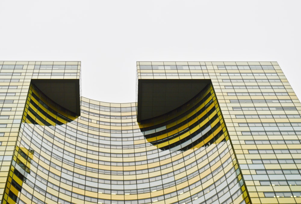 low angle photography of yellow and black building structure