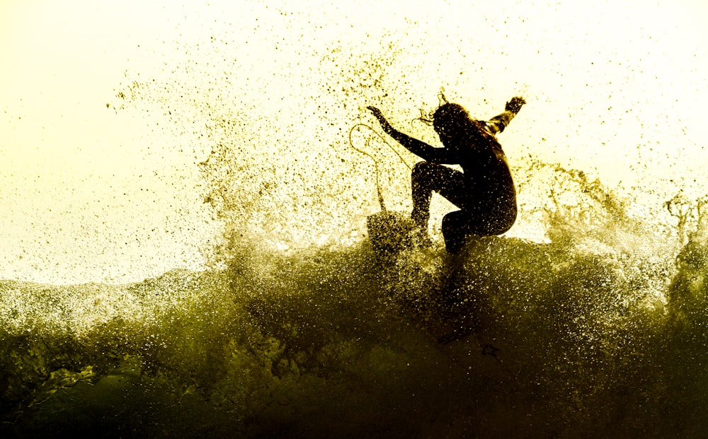 man surfing on high waves