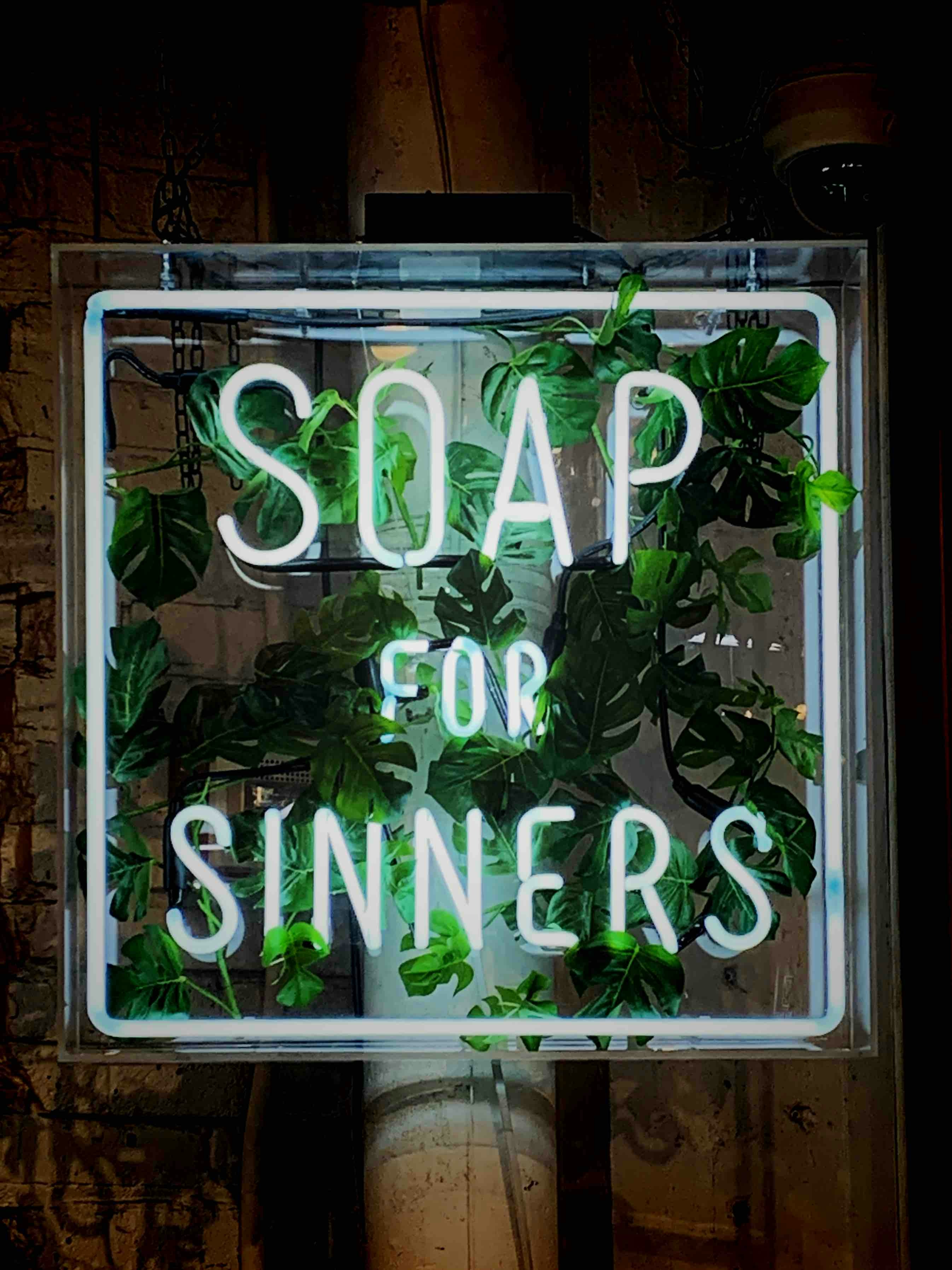 white Soap for Sinners neon signage with green vines photo Free Shop