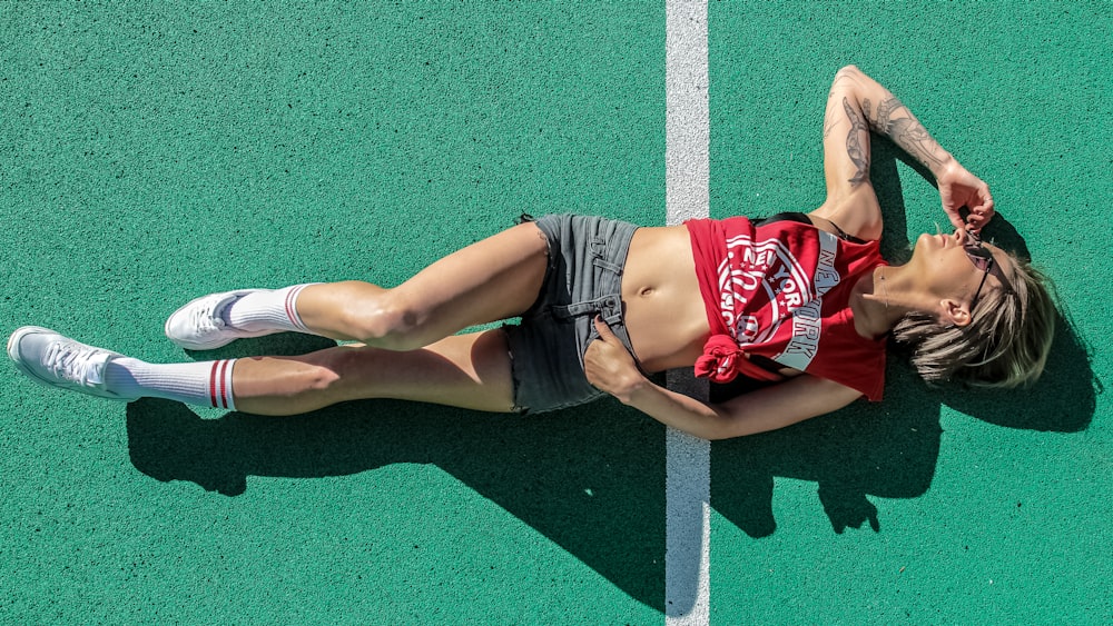 woman lying on sports field