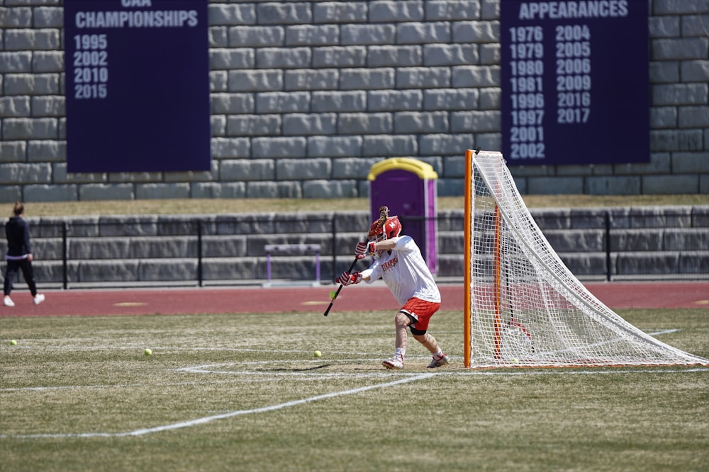 man playing lacrosse at the field