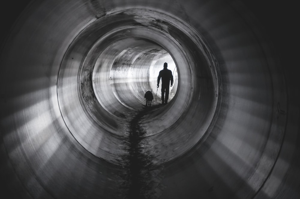 man and animal inside tunnel