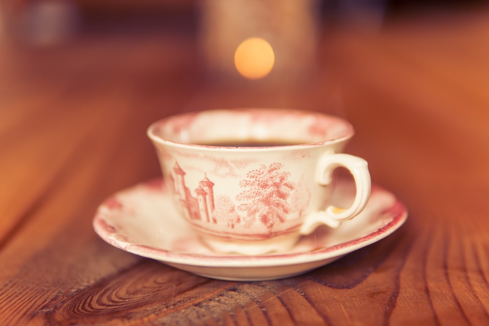 selective focus photography of white and pink teacup
