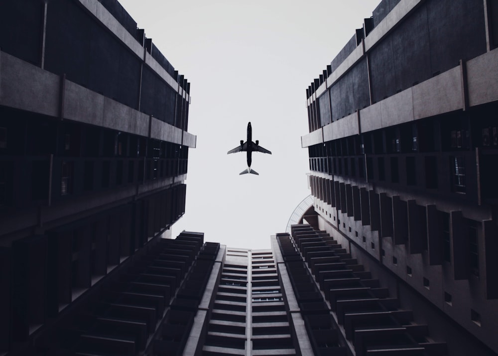 low angle photo of airliner and buildings