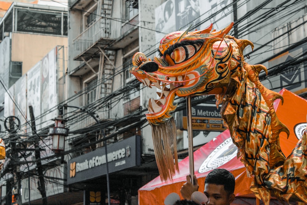 yellow dragon dance on street during daytime