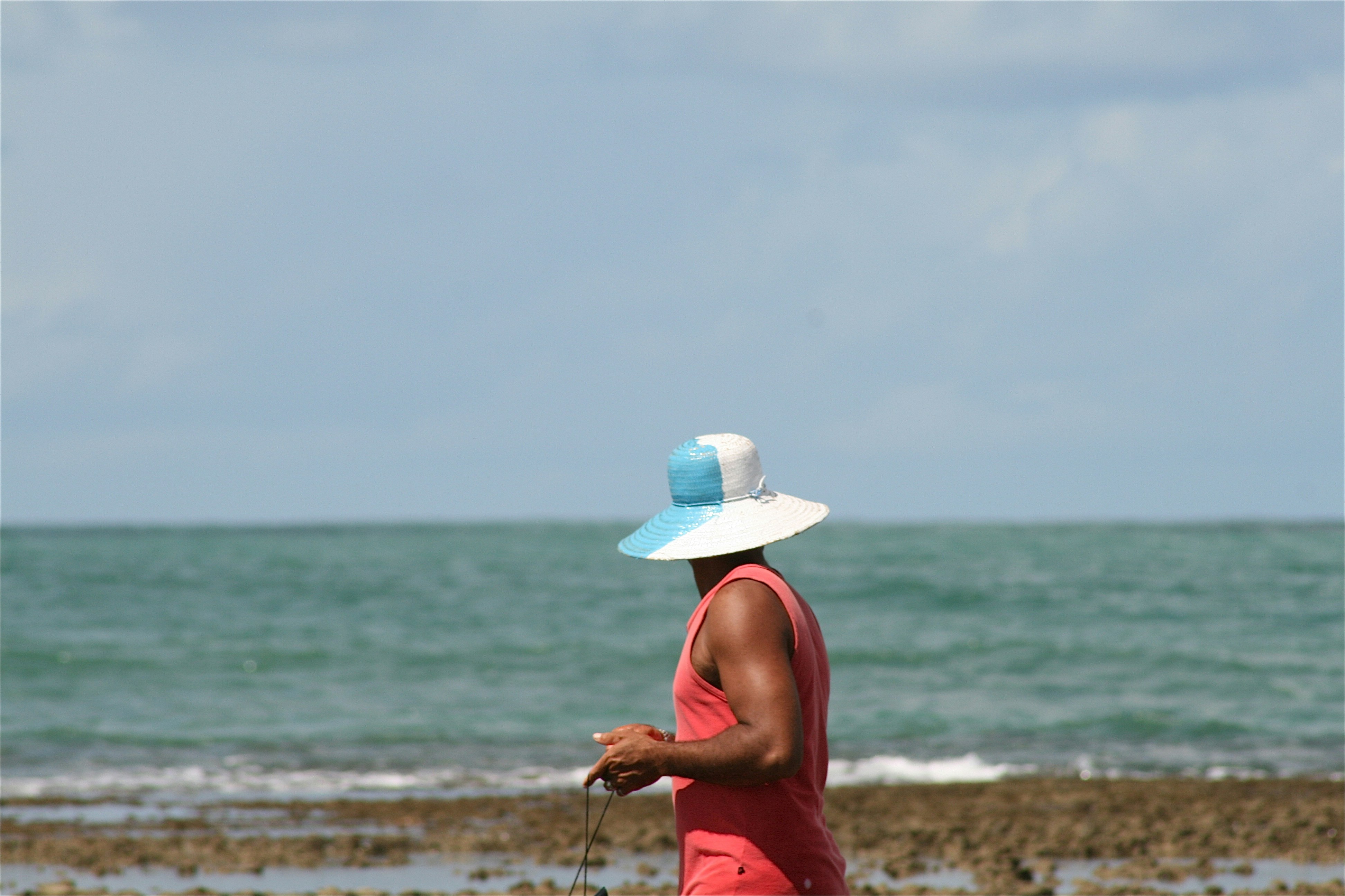 man wearing blue and white sun hat