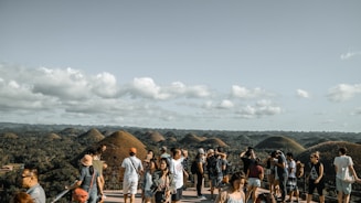 A group of diverse travelers enjoying a scenic viewpoint together.
