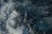 Waves in a deep blue ocean with frothy whitecaps creating a dynamic and textured water surface.