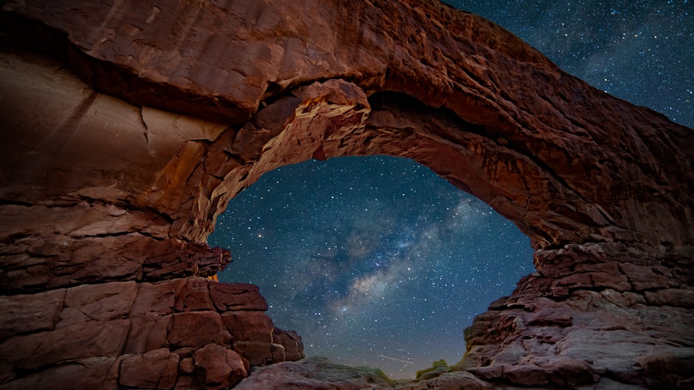 mountain cliff under starry night