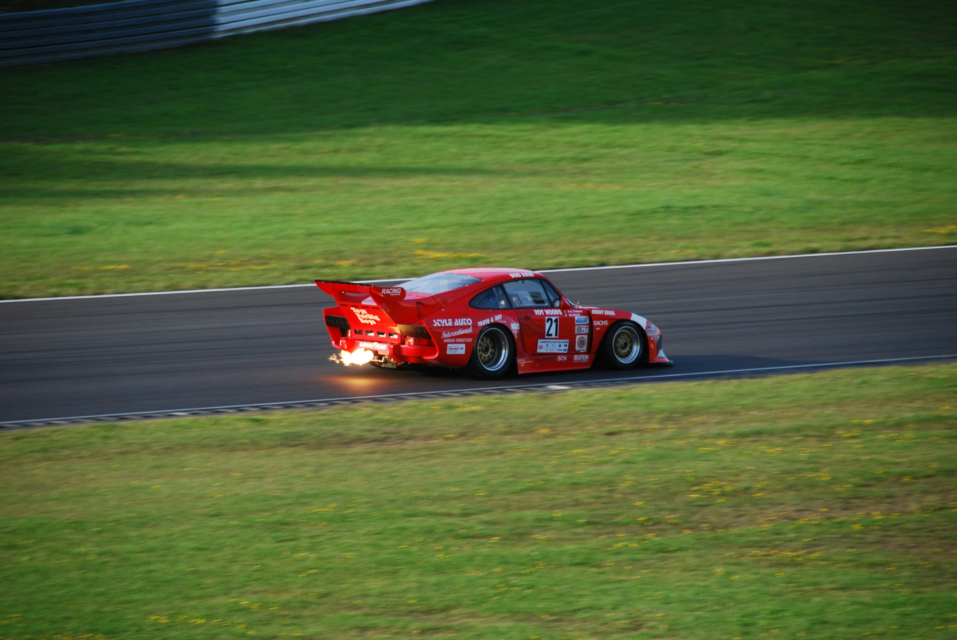 red F1 car on gray road
