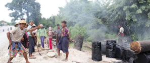 Technicians from Bio Energy Ingenieros inspecting the charcoal production process outdoors