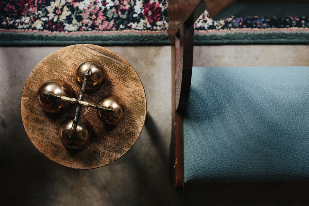 brass-colored decor beside leather padded brown wooden framed bench