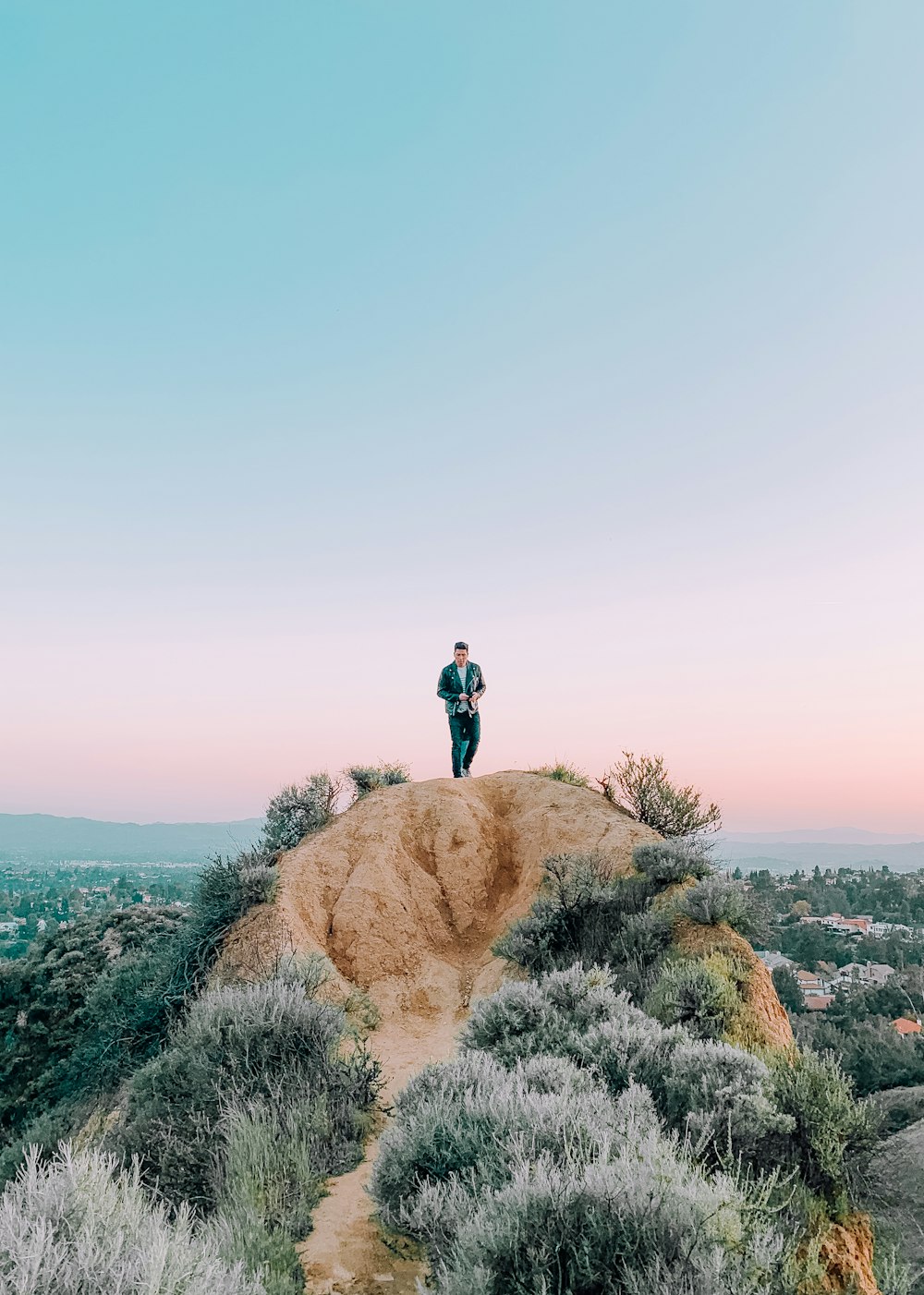 man standing on hill during daytime