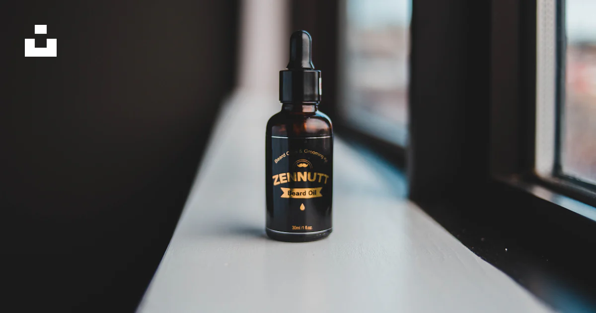 Black and gold-labeled dropper bottle placed near window photo – Free ...