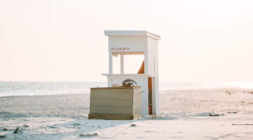 white wooden shed near body of water