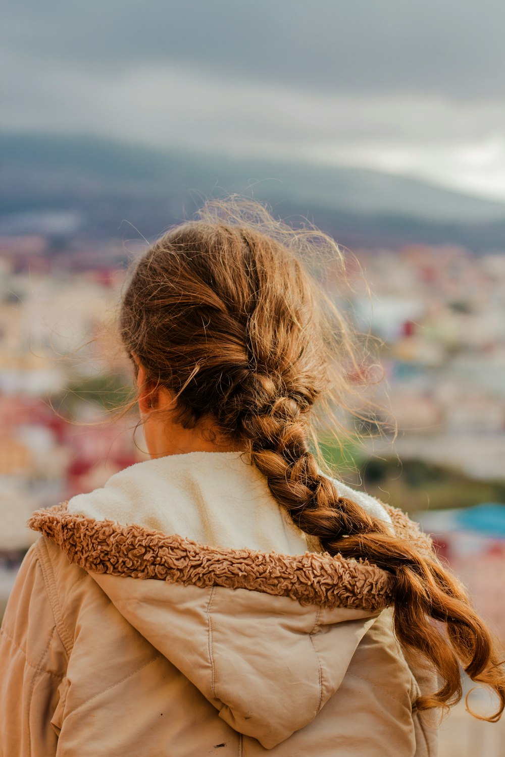 woman facing village outdoors during daytime